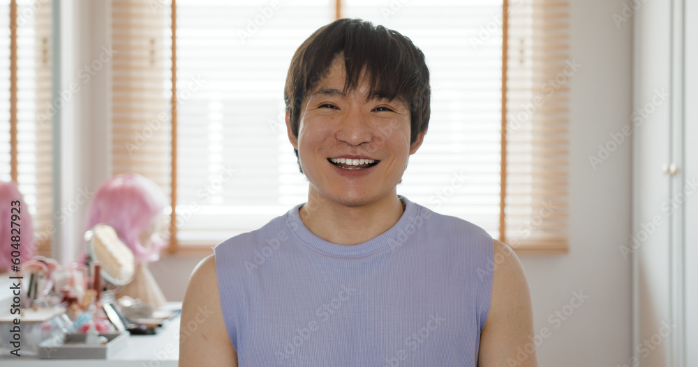 Gen Z Gay queer man non-binary beauty blogger makeup artist at home. Real asia LGBT young guy adult people happy relax smile sitting at mirror dressing room looking at camera proud and LGBTQ pride. Gen Z Gay queer man non-binary beauty blogger makeup artist at home. Real asia LGBT young guy adult people happy relax smile sitting at mirror dressing room looking at camera proud and LGBTQ pride.