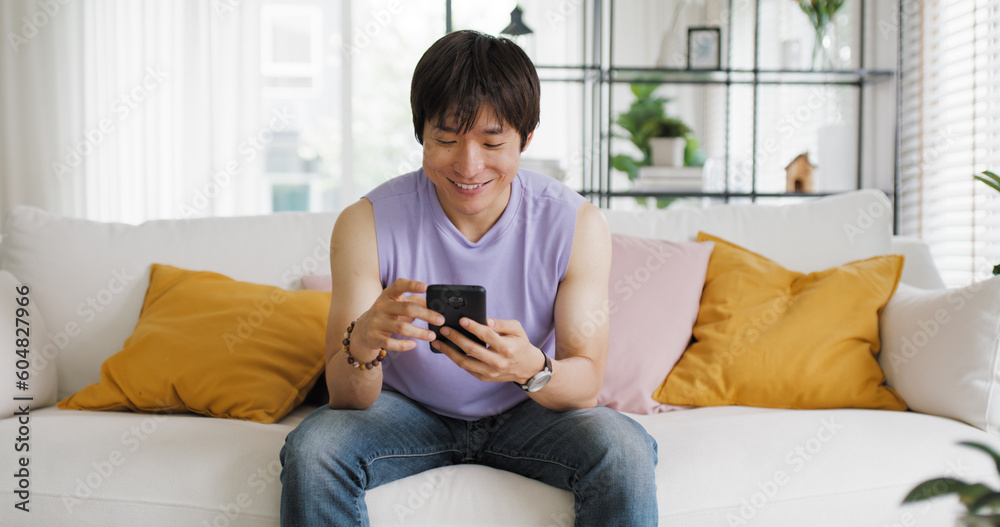 Gen Z queer man non-binary sitting easy relax happy read news on web page app at home sofa. Asia people LGBT young adult guy play web3, store shop e-commerce buyer, virtual retail network cyber paying Gen Z queer man non-binary sitting easy relax happy read news on web page app at home sofa. Asia people LGBT young adult guy play web3, store shop e-commerce buyer, virtual retail network cyber paying