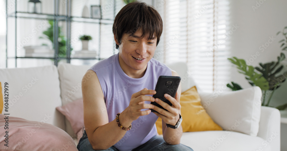 Adult people asia single LGBT gay man sitting at home sofa looking at dating game tinder app on mobile phone. Relax smile choose lover enjoy playing right swipe to find love couple match flirt chat. Adult people asia single LGBT gay man sitting at home sofa looking at dating game tinder app on mobile phone. Relax smile choose lover enjoy playing right swipe to find love couple match flirt chat.