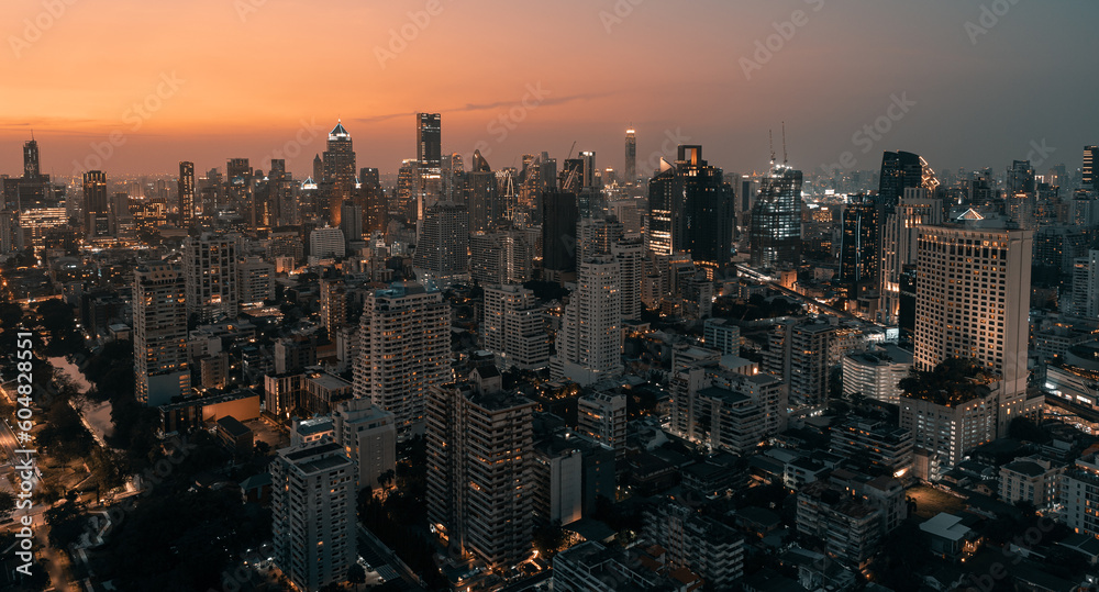 Obraz premium Skyline panorama of Illuminated Bangkok city metropolis in twilight during the sunset. Scenic panoramic urban colorful cityscape of modern city on dusk. High-angle view
