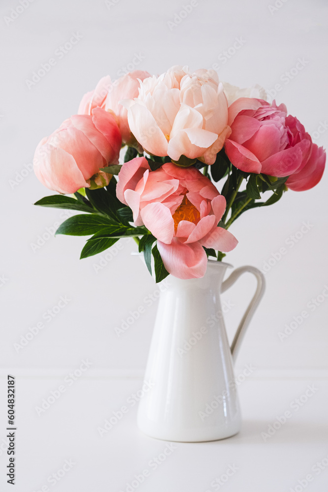 Beautiful bouquet of fresh coral peony flowers in full bloom in vase. Floral still life with blooming peonies. Beautiful bouquet of fresh coral peony flowers in full bloom in vase. Floral still life with blooming peonies.