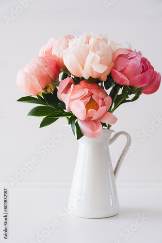 Fototapeta Naklejka Na Ścianę i Meble -  Beautiful bouquet of fresh coral peony flowers in full bloom in vase. Floral still life with blooming peonies.