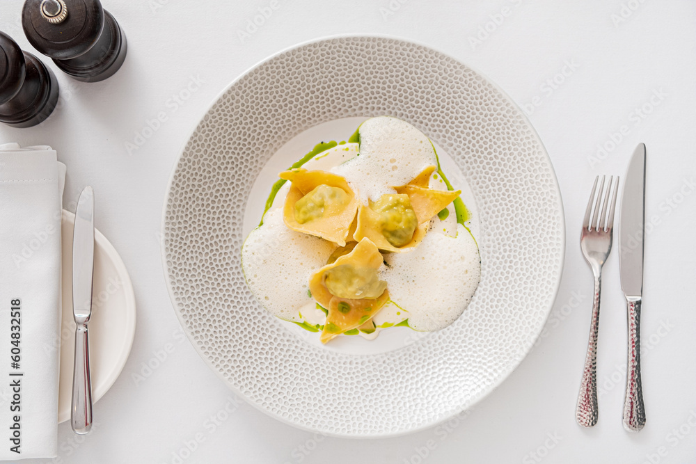 Tasty cooked ravioli with cream sauce