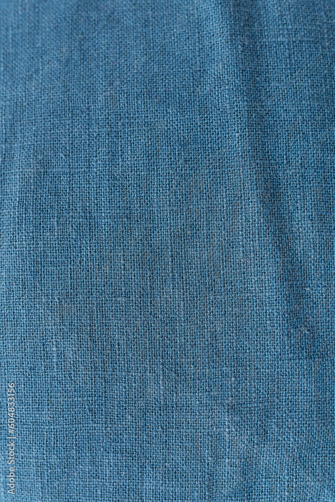 Classic blue color, vertical photo. Linen fabric blue background texture. Crumpled linen dark blue fabric. Classic blue color, vertical photo. Linen fabric blue background texture. Crumpled linen dark blue fabric.