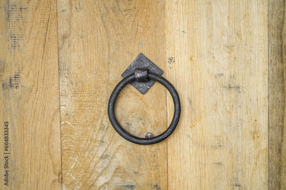 Rustic wooden background with metal handle.
Rustic wooden background with metal handle.