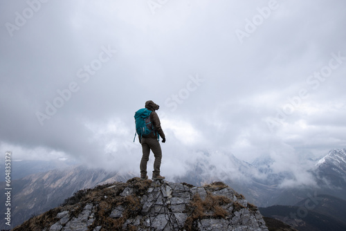 Successful woman hiker hiking at mountain top in tibet