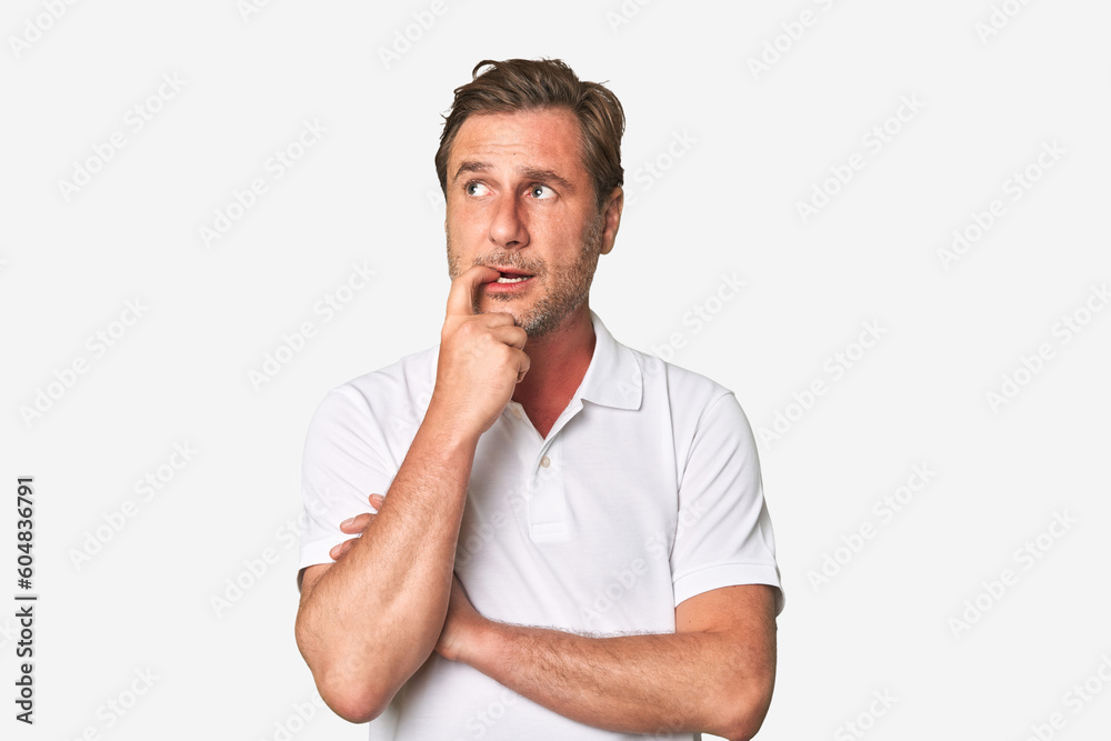 A middle-aged man isolated looking sideways with doubtful and skeptical expression. A middle-aged man isolated looking sideways with doubtful and skeptical expression.