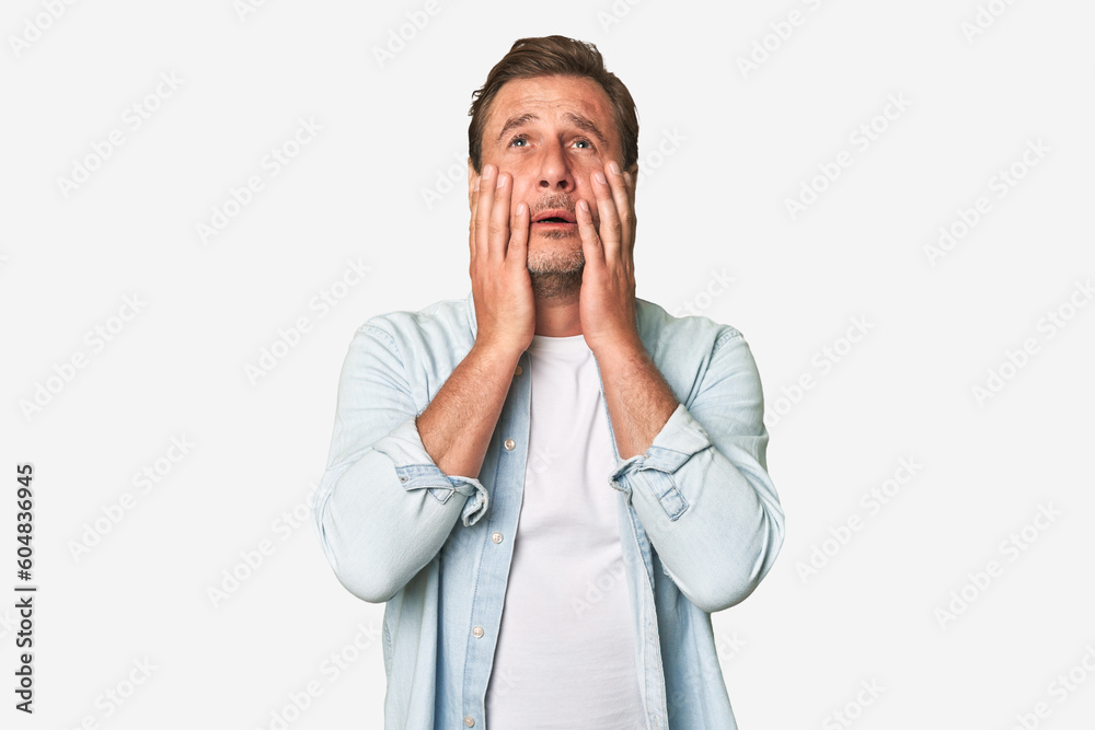 A middle-aged man isolated whining and crying disconsolately. A middle-aged man isolated whining and crying disconsolately.