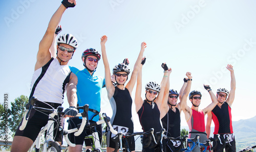 Cyclists cheering together outdoors