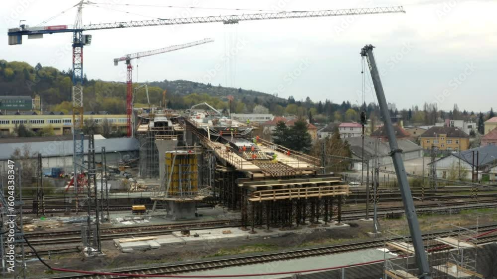 Tower cranes at construction of bridge across multiple railway tracks. Tower cranes at construction of bridge across multiple railway tracks.