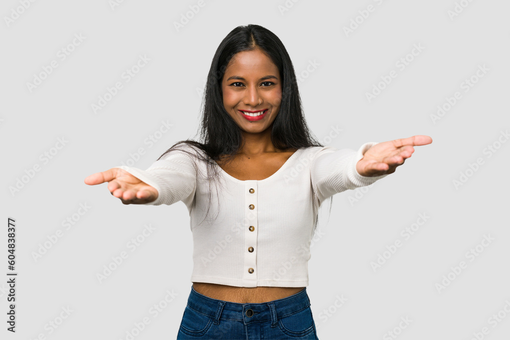 Young Indian woman cut out isolated on white background showing a welcome expression. Young Indian woman cut out isolated on white background showing a welcome expression.