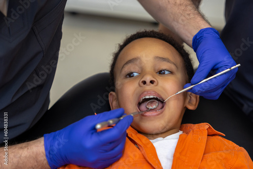 Dentist and his assistant treating boys teeth
