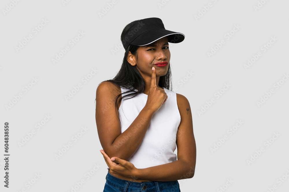 Young Indian woman cut out isolated on white background contemplating, planning a strategy, thinking about the way of a business. Young Indian woman cut out isolated on white background contemplating, planning a strategy, thinking about the way of a business.