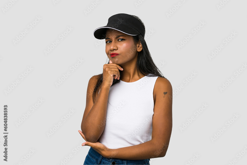 Young Indian woman cut out isolated on white background thinking and looking up, being reflective, contemplating, having a fantasy. Young Indian woman cut out isolated on white background thinking and looking up, being reflective, contemplating, having a fantasy.