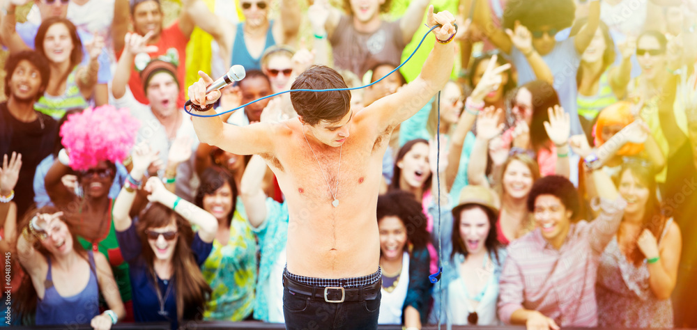 Performer dancing on stage with fans cheering  at music festival