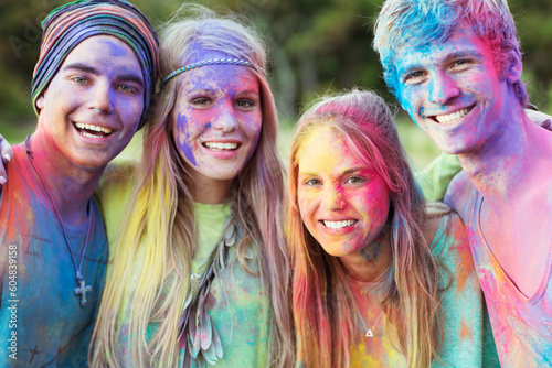 Close up portrait of friends covered in chalk dye at music festival