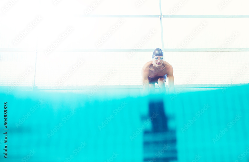 Swimmers poised on starting blocks - obrazy, fototapety, plakaty 