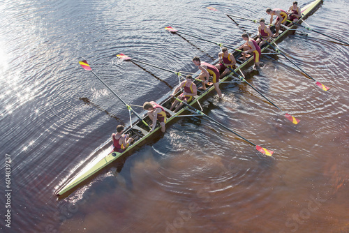 Rowing team in scull on lake photo