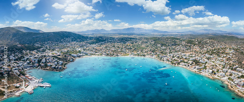 Fototapeta Naklejka Na Ścianę i Meble -  Wide panoramic aerial view of the town and bay of Porto Rafti, popular destination for Athenians during summer time, Attica, Greece