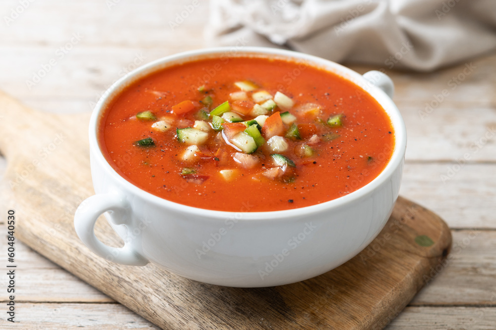 Traditional Spanish gazpacho soup in bowl on wooden table. Traditional Spanish gazpacho soup in bowl on wooden table.