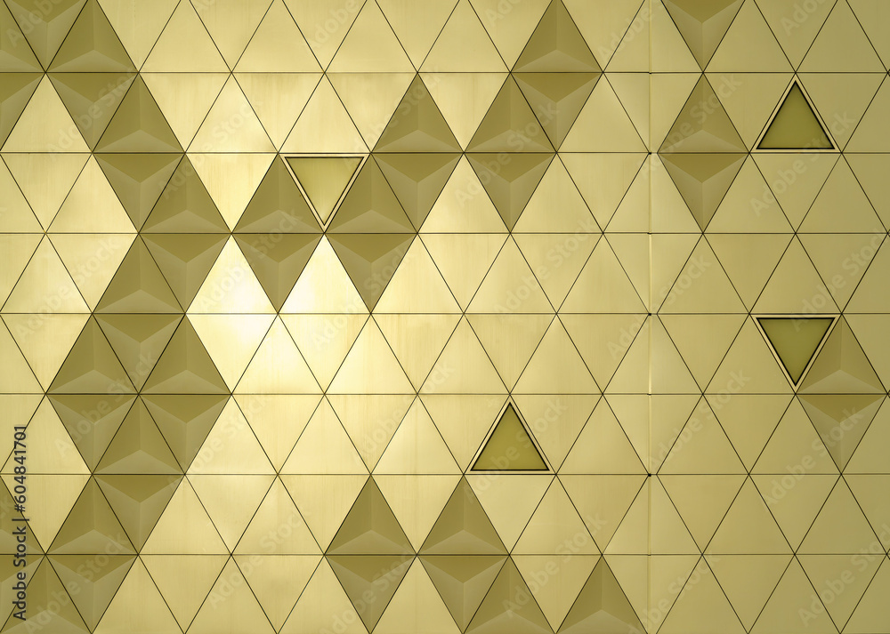 Golden diamond-shaped polished metal cladding panels of a modern ...