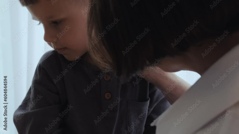 Grandmother and grandson communicate, look into each other's eyes, hug and smile at each other. Family, love, comfort. Grandmother and grandson communicate, look into each other's eyes, hug and smile at each other. Family, love, comfort.