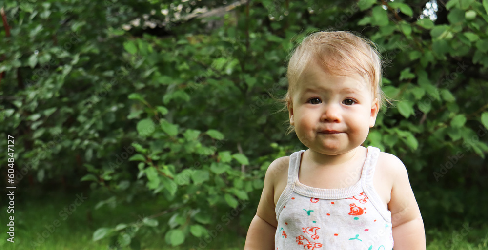 portrait of a smiling little baby on the green nature background portrait of a smiling little baby on the green nature background