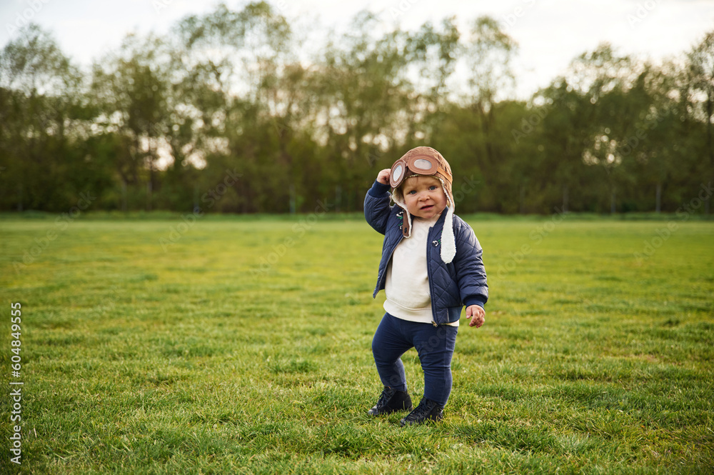 Cute little boy in aviator glasses is standing on the summer field Cute little boy in aviator glasses is standing on the summer field