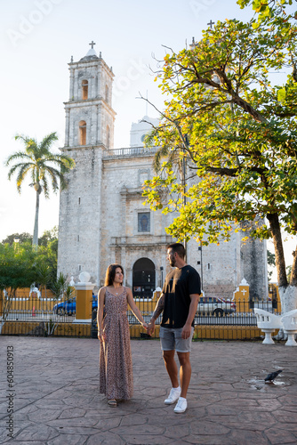 Young tourist couple in love in front of San Servacio Church in Valladolid, Mexico. photo