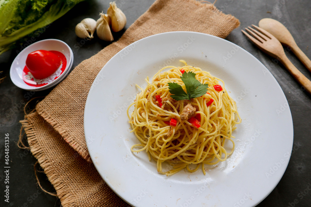 aglio e olio. Italian Pasta Spaghetti, aglio olio e pepperoni ,spaghetti with garlics, olive oil and chilli peppers on plate on table
