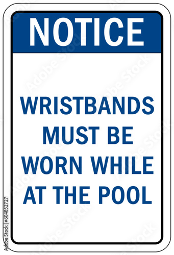 Pool pass required sign and labels wristbands must be worn while at the pool