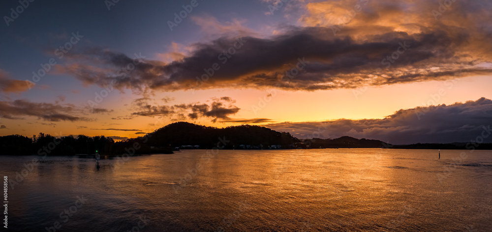 After the rain sunrise panorama at the waterfront