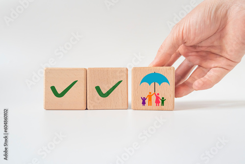 family life insurance on wooden block.happy family idea concept.