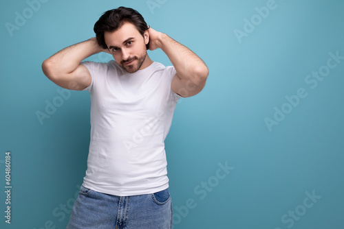 handsome bearded brunette man in white t-shirt with copyspace