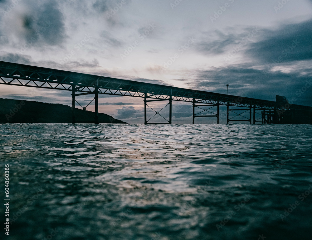 Obraz premium Bridge over the sea in the sunset