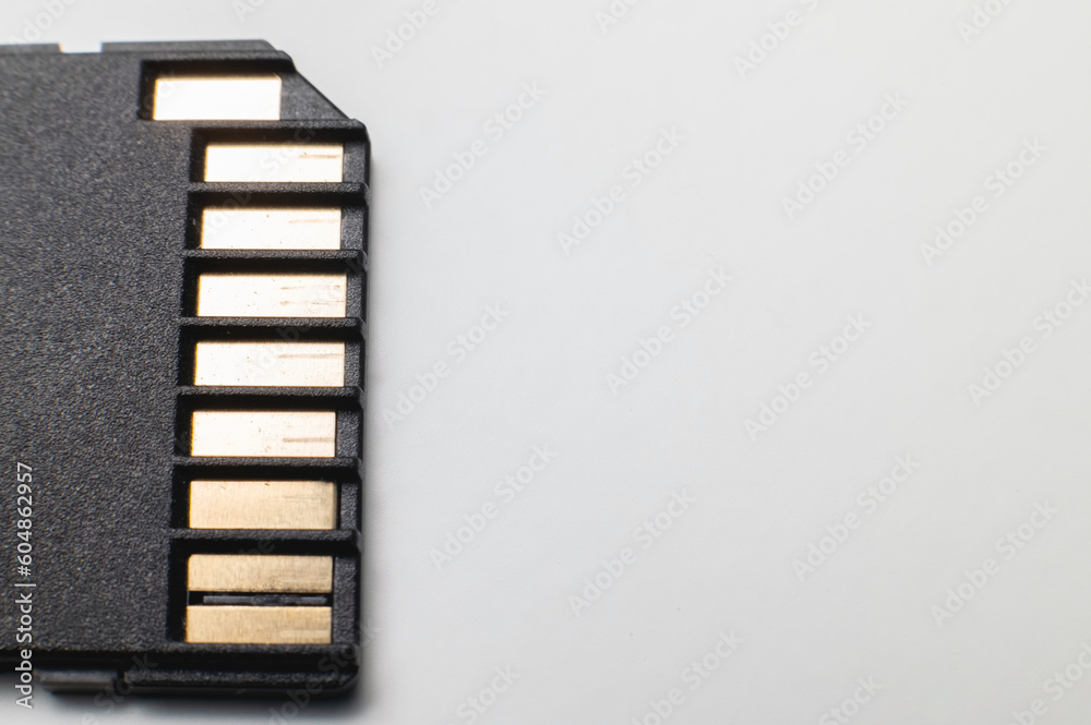 The contact group of the SD flash memory card is black on a gray background. macro close-up The contact group of the SD flash memory card is black on a gray background. macro close-up