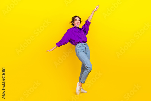 Full length photo of careless woman celebrate begin weekend chill after hard working day hands up chill isolated on yellow color background