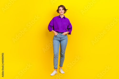 Full size photo of pretty young girl hand pockets posing dressed stylish purple smart casual outfit isolated on yellow color background