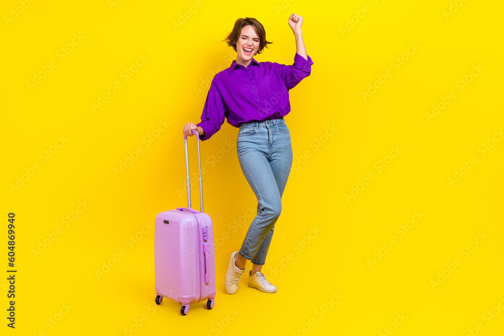 Full length photo of lucky funky woman dressed purple shirt finally doing new vacation isolated yellow color background