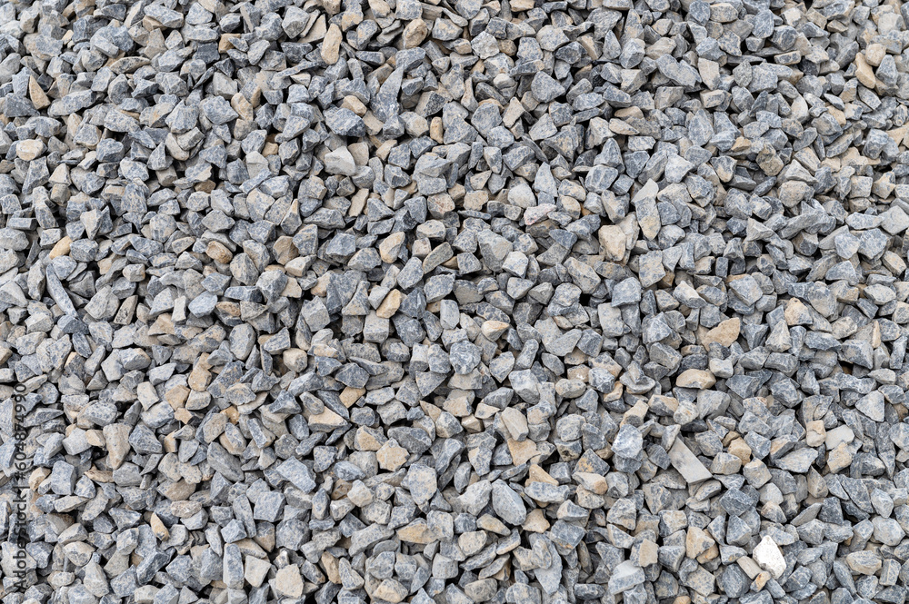 Grey granite gravel background for mix concrete. Crushed stone as a background. Construction rock.
