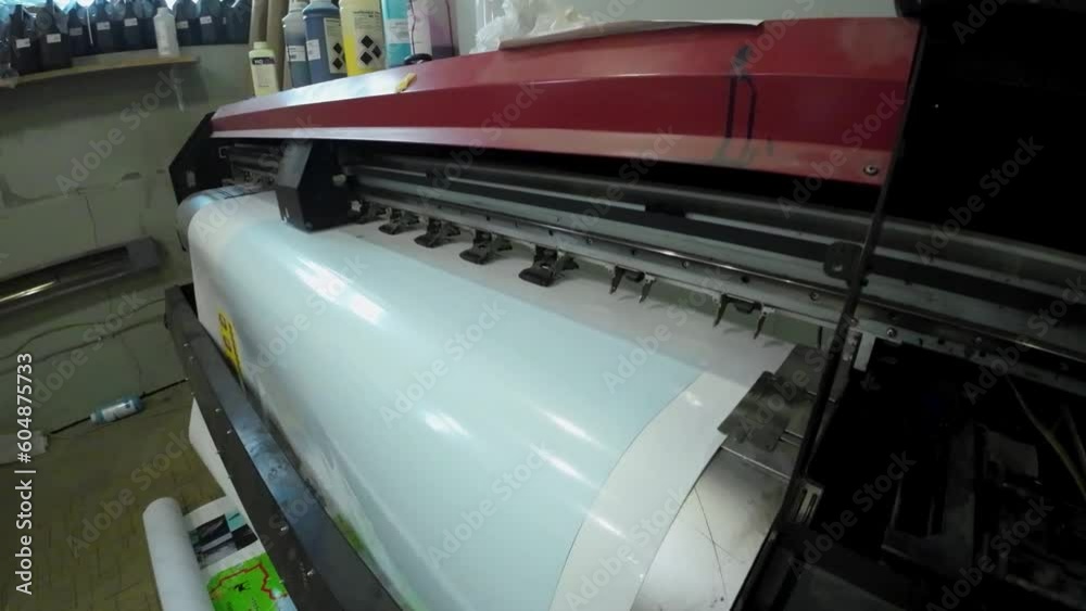 Printing machine in printing house printing images on sticky film Printing machine in printing house printing images on sticky film