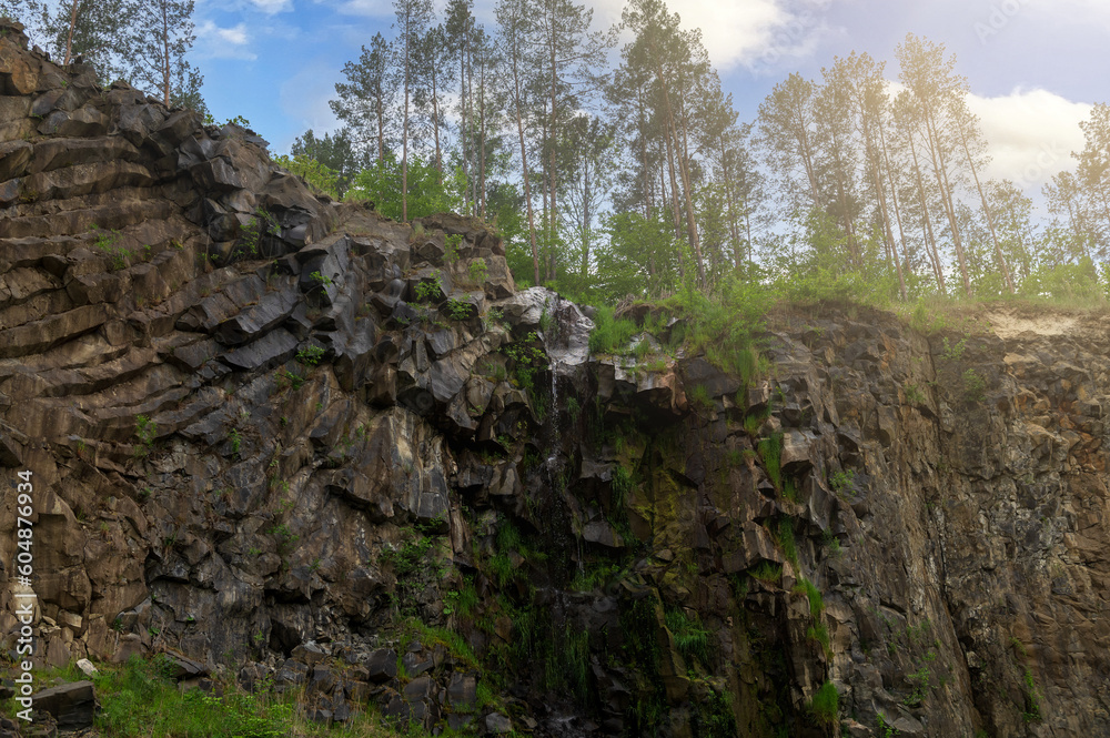 Basalt pillars in a quarry. Natural basalt rock columns closeup texture. Abstract natural background or texture. Basalt pillars in a quarry. Natural basalt rock columns closeup texture. Abstract natural background or texture.