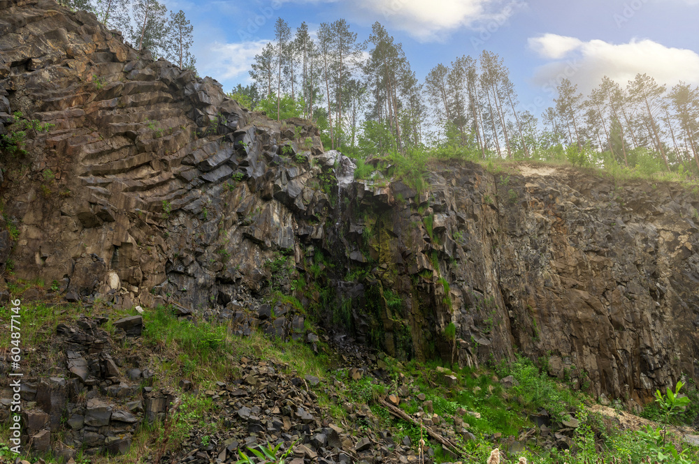 Basalt pillars in a quarry. Natural basalt rock columns closeup texture. Abstract natural background or texture. Basalt pillars in a quarry. Natural basalt rock columns closeup texture. Abstract natural background or texture.