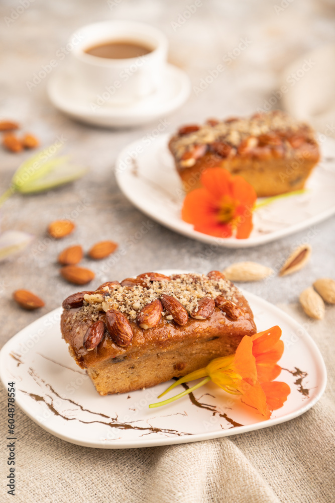 Caramel and almond cake on brown concrete, side view, selective focus Caramel and almond cake on brown concrete, side view, selective focus