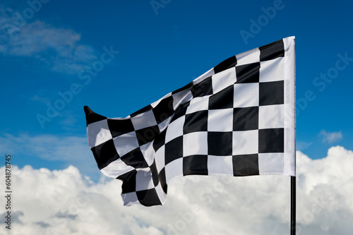Checkered flag on blue sky © xy
