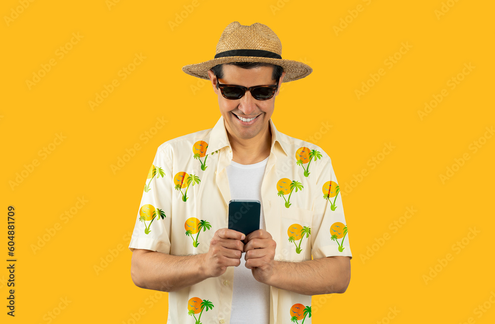 Latin man texting using smartphone over isolated yellow background with a happy face standing and smiling with a confident smile showing teeth Latin man texting using smartphone over isolated yellow background with a happy face standing and smiling with a confident smile showing teeth
