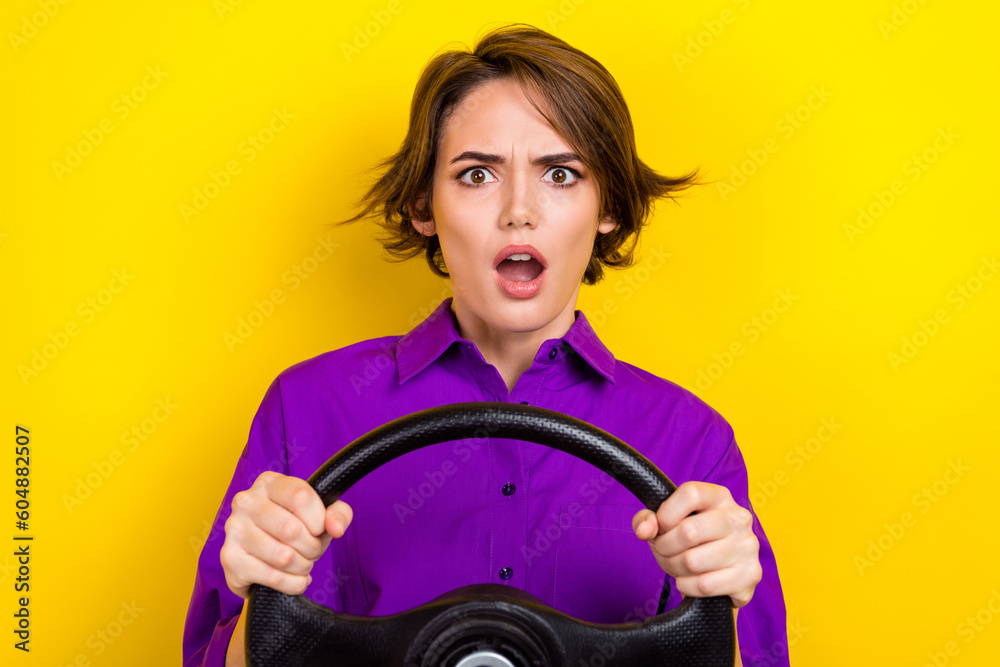 Portrait of impressed crazy person open mouth arms hold wheel staring speechless isolated on yellow color background - obrazy, fototapety, plakaty 