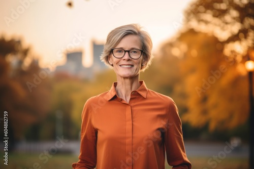 Lifestyle portrait photography of a glad mature woman wearing an elegant long-sleeve shirt against a vibrant city park background. With generative AI technology