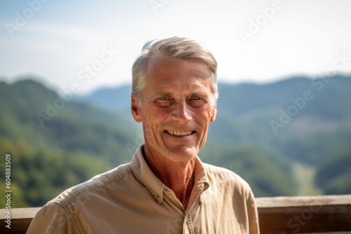 Environmental portrait photography of a glad mature man wearing a casual short-sleeve shirt against a scenic mountain overlook background. With generative AI technology