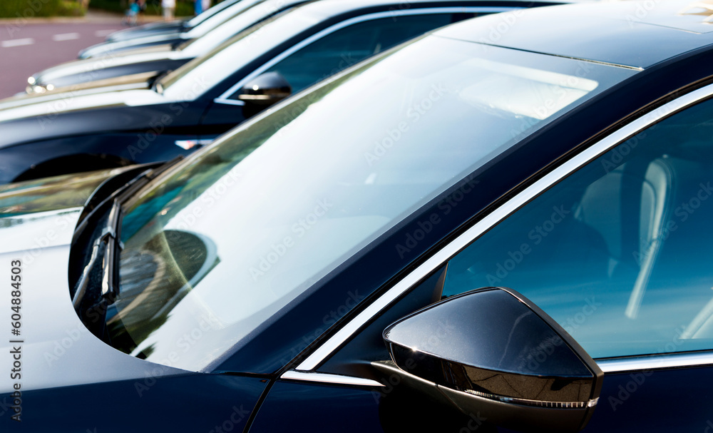 Group of black cars parked in a row Group of black cars parked in a row